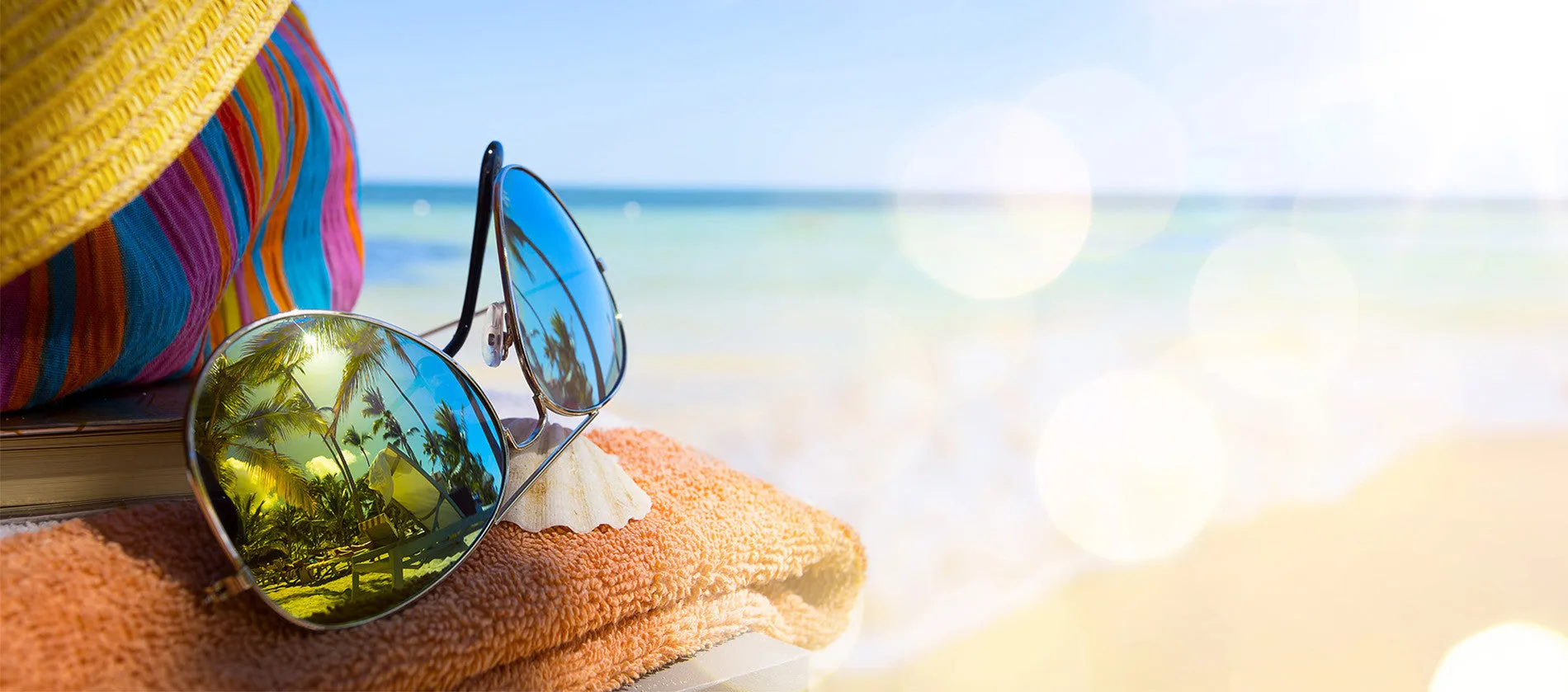 Colorful beach setting with sunhat and towel